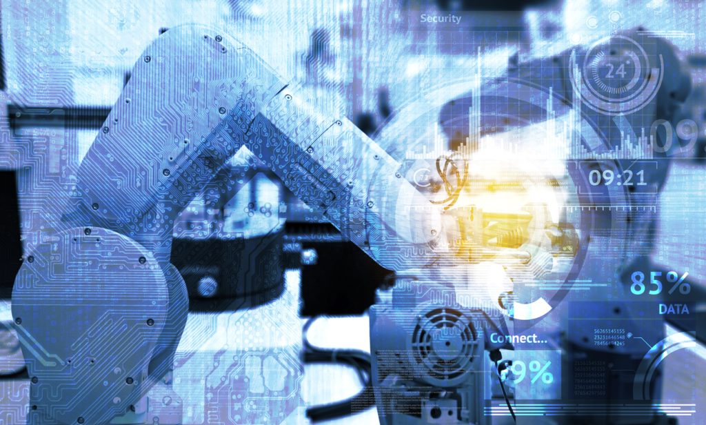Industrial internet of things and industry 4.0 concept. Abstract blue background of technology graphic and automation wireless control robotic machine in smart factory with flare light effect.